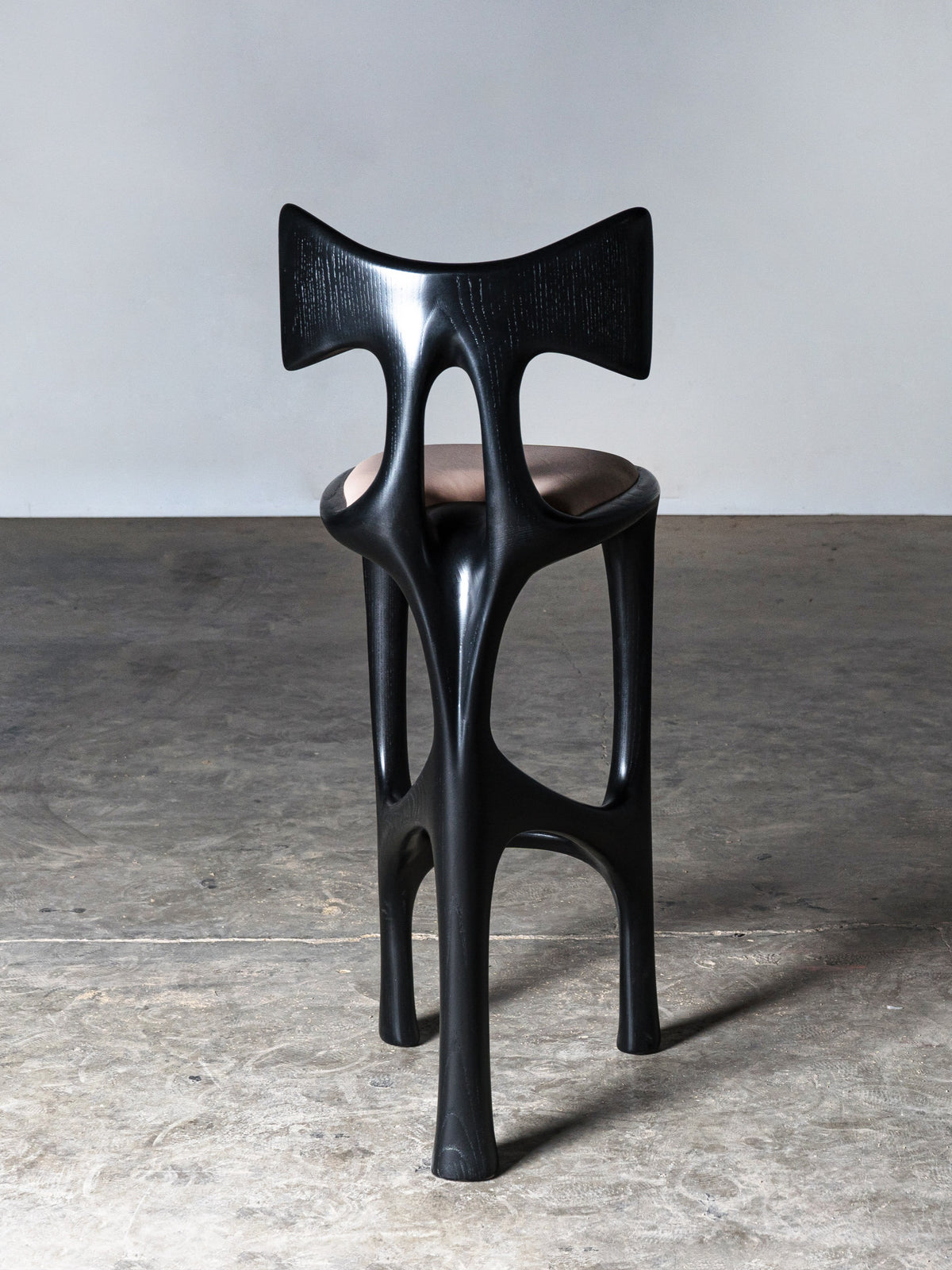 Tripa Stool in Ebony stain on Ash Wood — side angle showing unique leg design