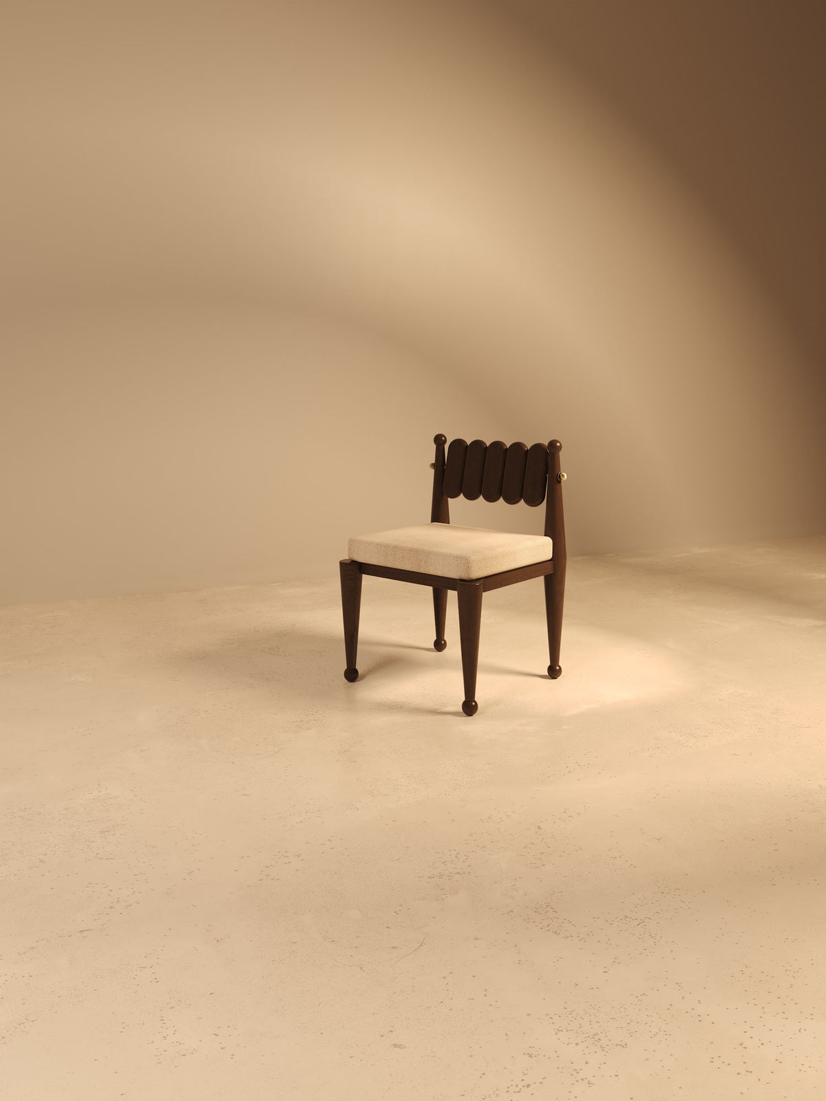 Simorgh III walnut chair with upholstered seat in studio setting