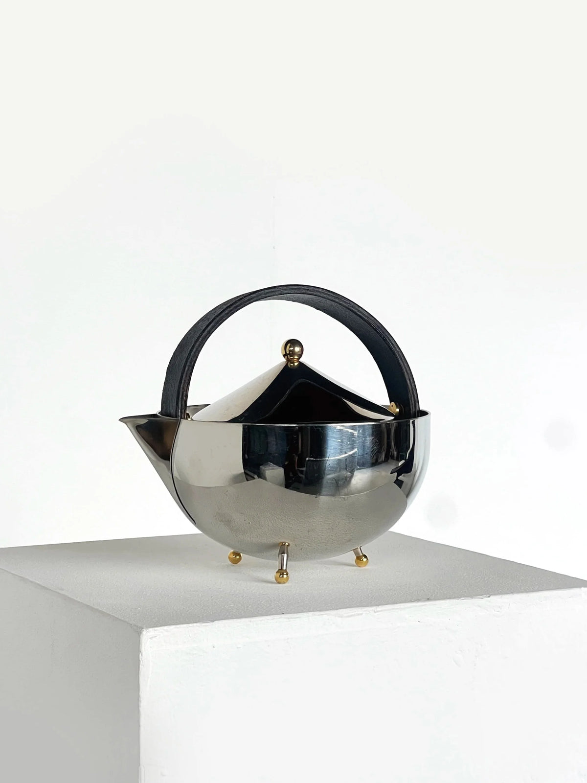 Carsten Jørgensen Teapot — side angle showing polished metal and leather handle