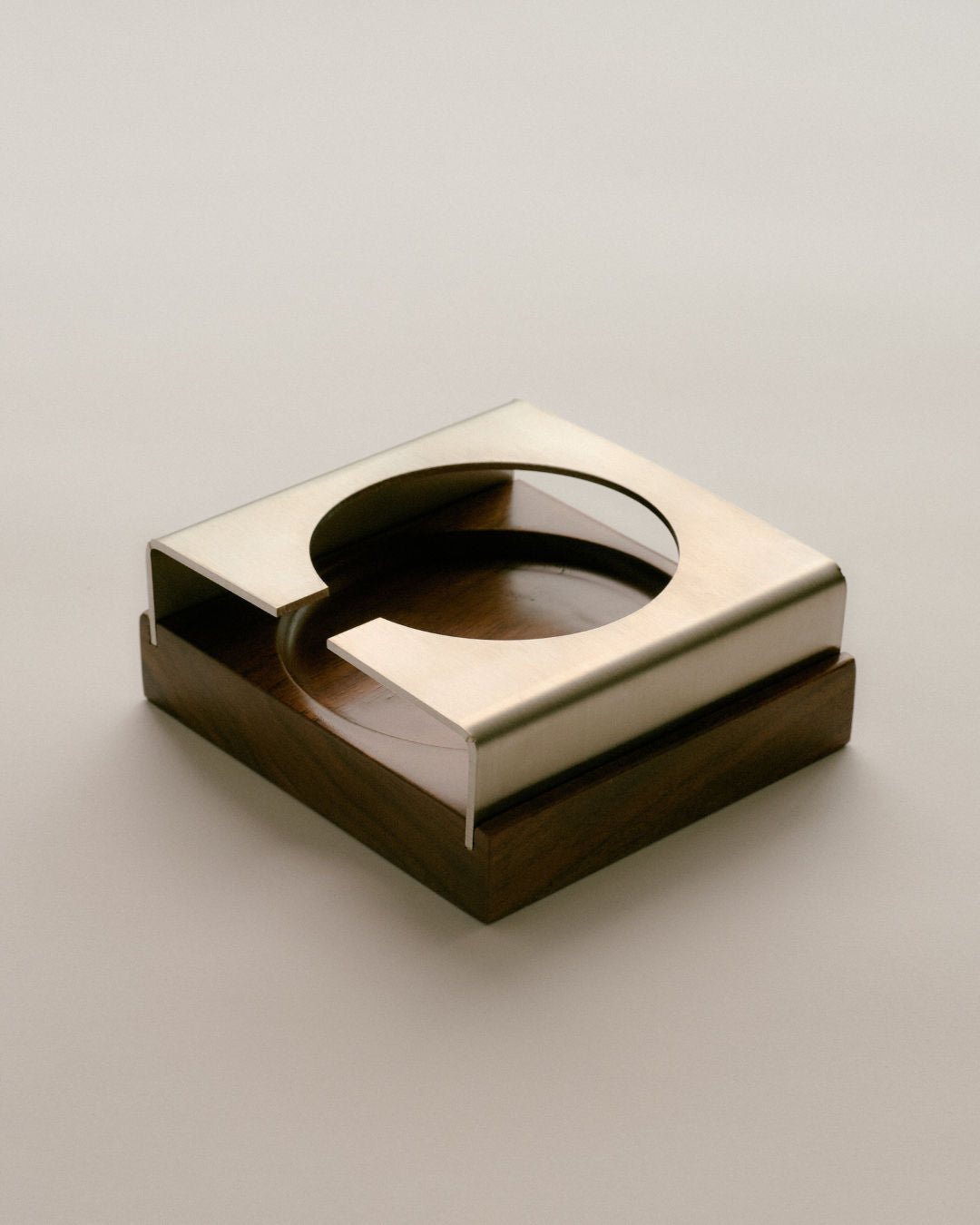 Modern square brass coaster with circular cutout detail view