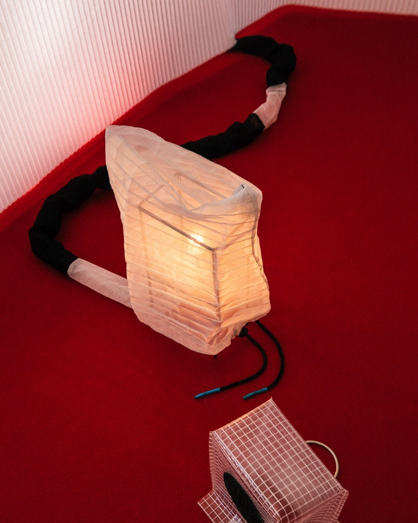 Consecuencia sculptural table lamp with pleated fabric shade detail