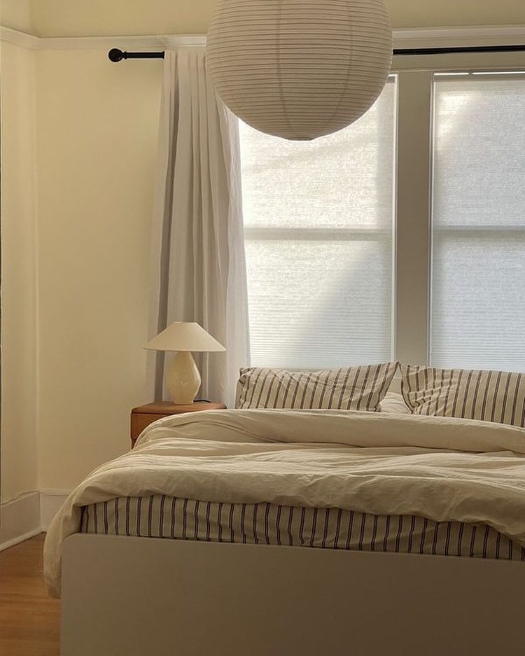 Beige conical glass table lamp styled in minimalist bedroom