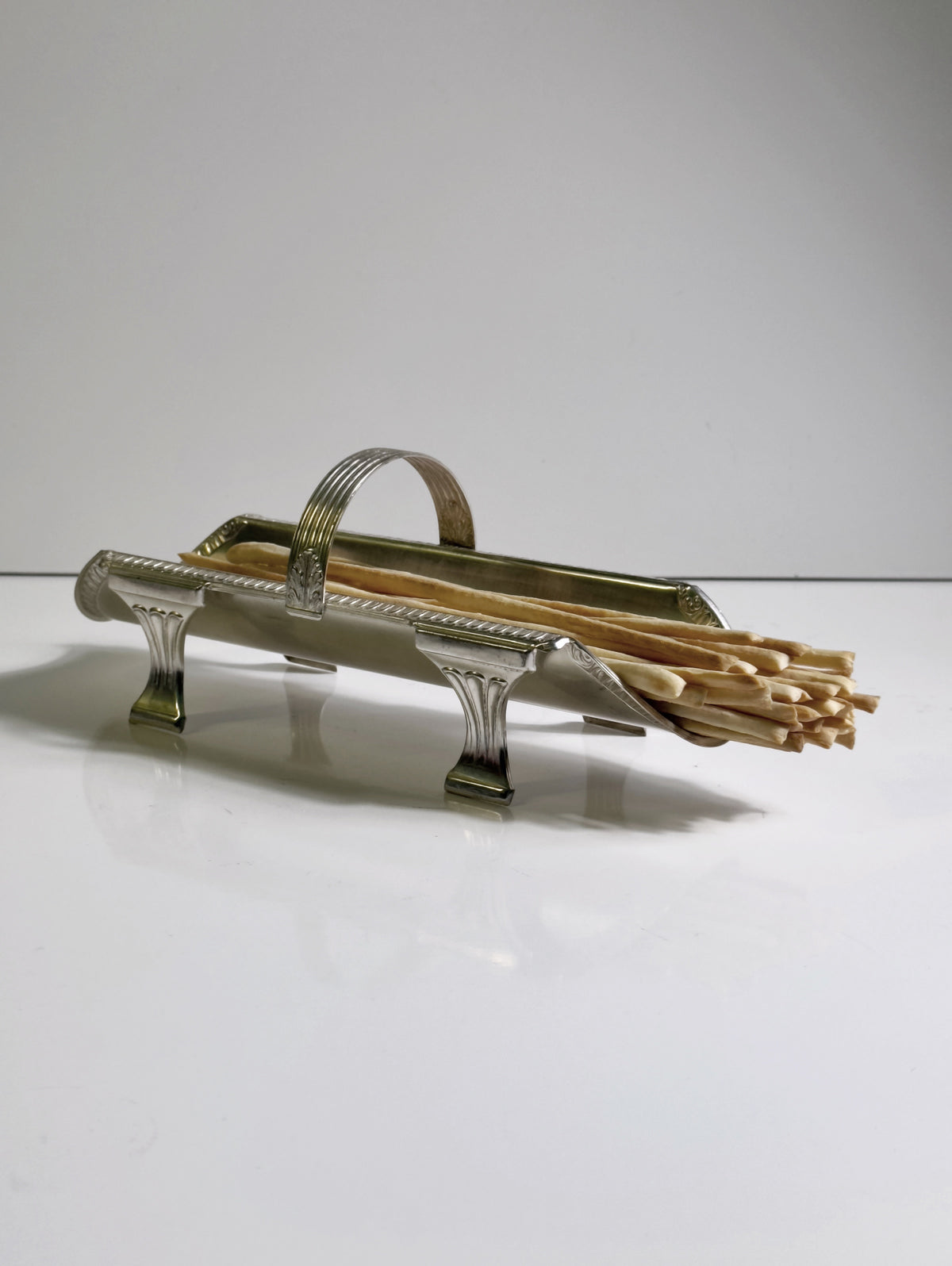 Art Deco brass grissini holder with breadsticks side view