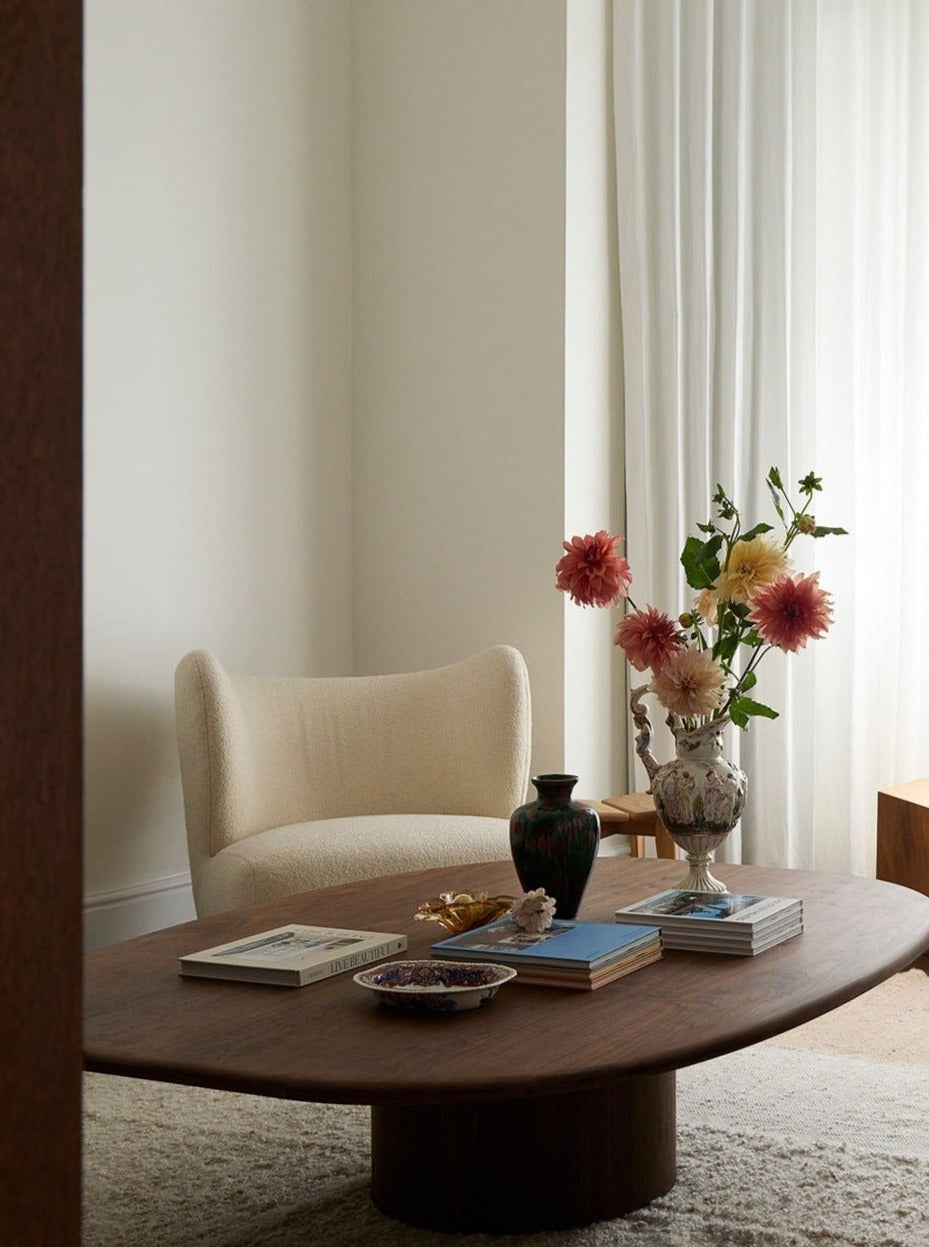 Circa Coffee Table in Walnut — close-up of rounded wood surface in living room