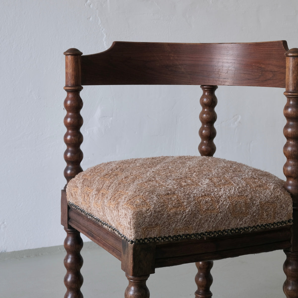 Antique corner chair with bobbin turned legs and upholstered seat