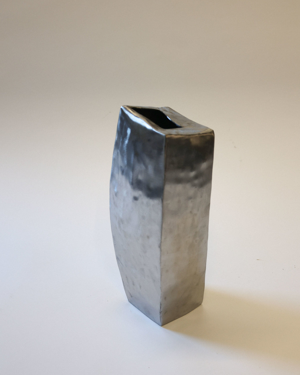 Hammered steel vase profile showing angular geometric form