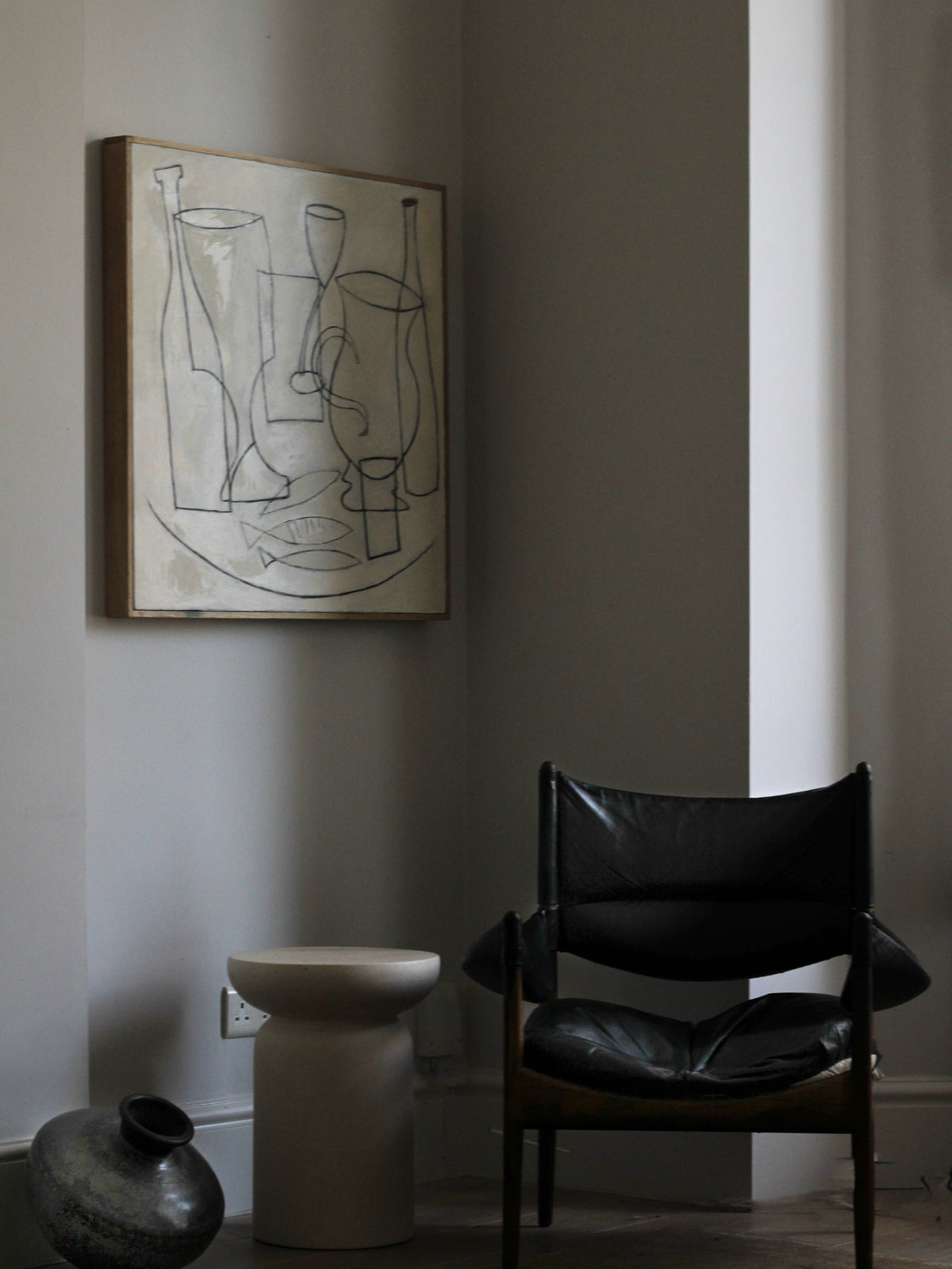 Still life painting with abstract vessels in modern interior setting