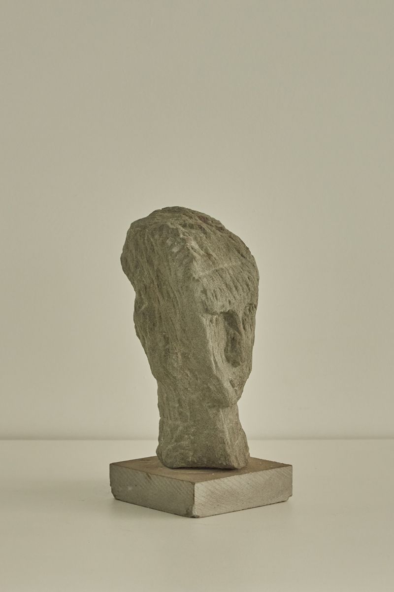 Aldo Nava carved stone head sculpture on geometric base, Italy 1950s