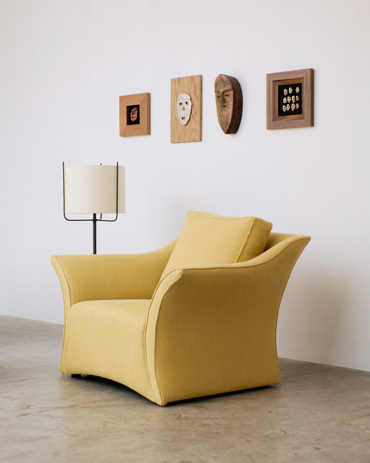 Amiga Floor Light — positioned beside yellow armchair in modern setting