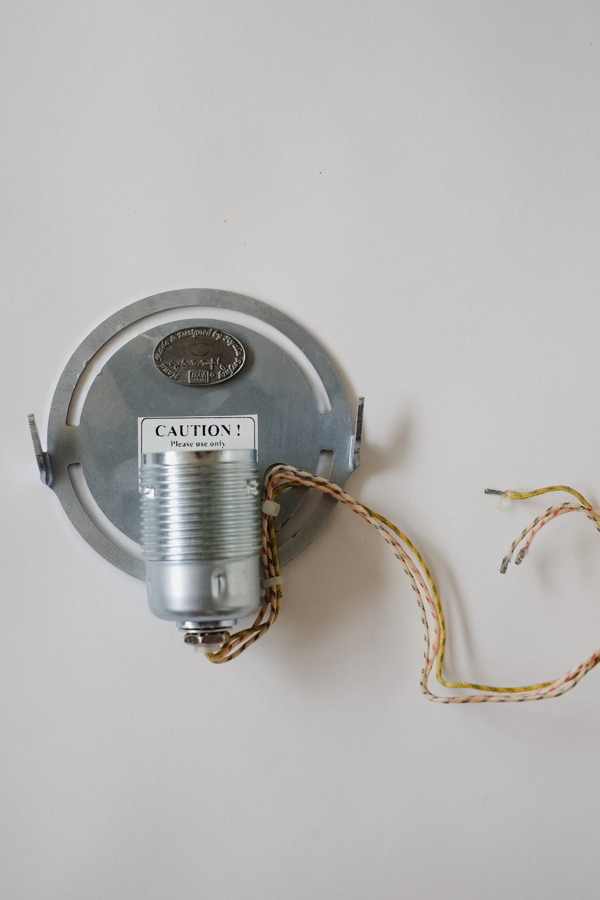 Maro Gold Silk Wall Lamp — Ayala Serfaty — close-up of metal socket and wiring