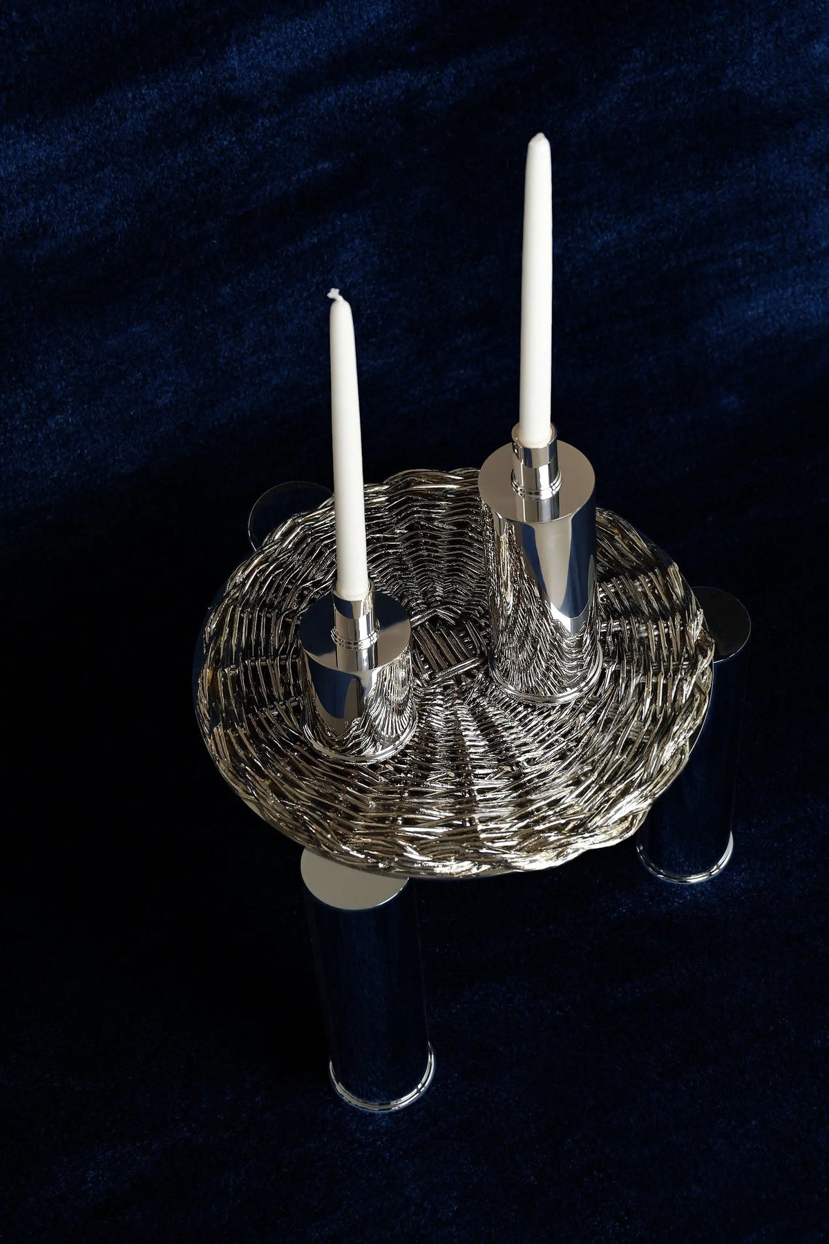 Silver Plated Candle Holders in Brass and Silver Plated Brass — top view on dark fabric background
