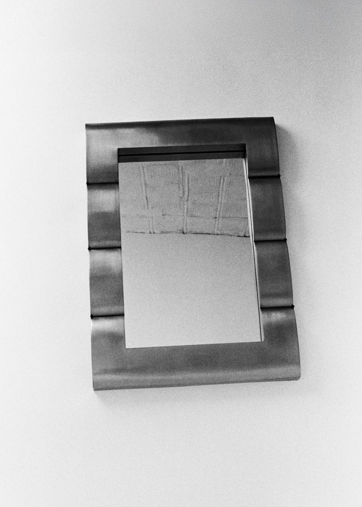 Mirror "Fluted Chambre", Contemporary Mirror in Steel — angled view against white wall