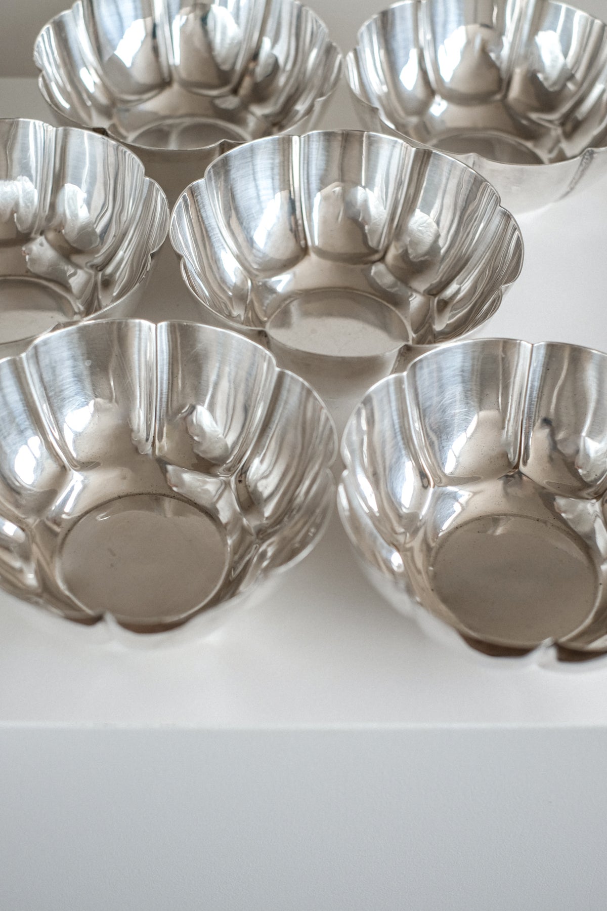 Set of 6 Silver-Plated Bowls 1960s — top view showing reflective surfaces on white background