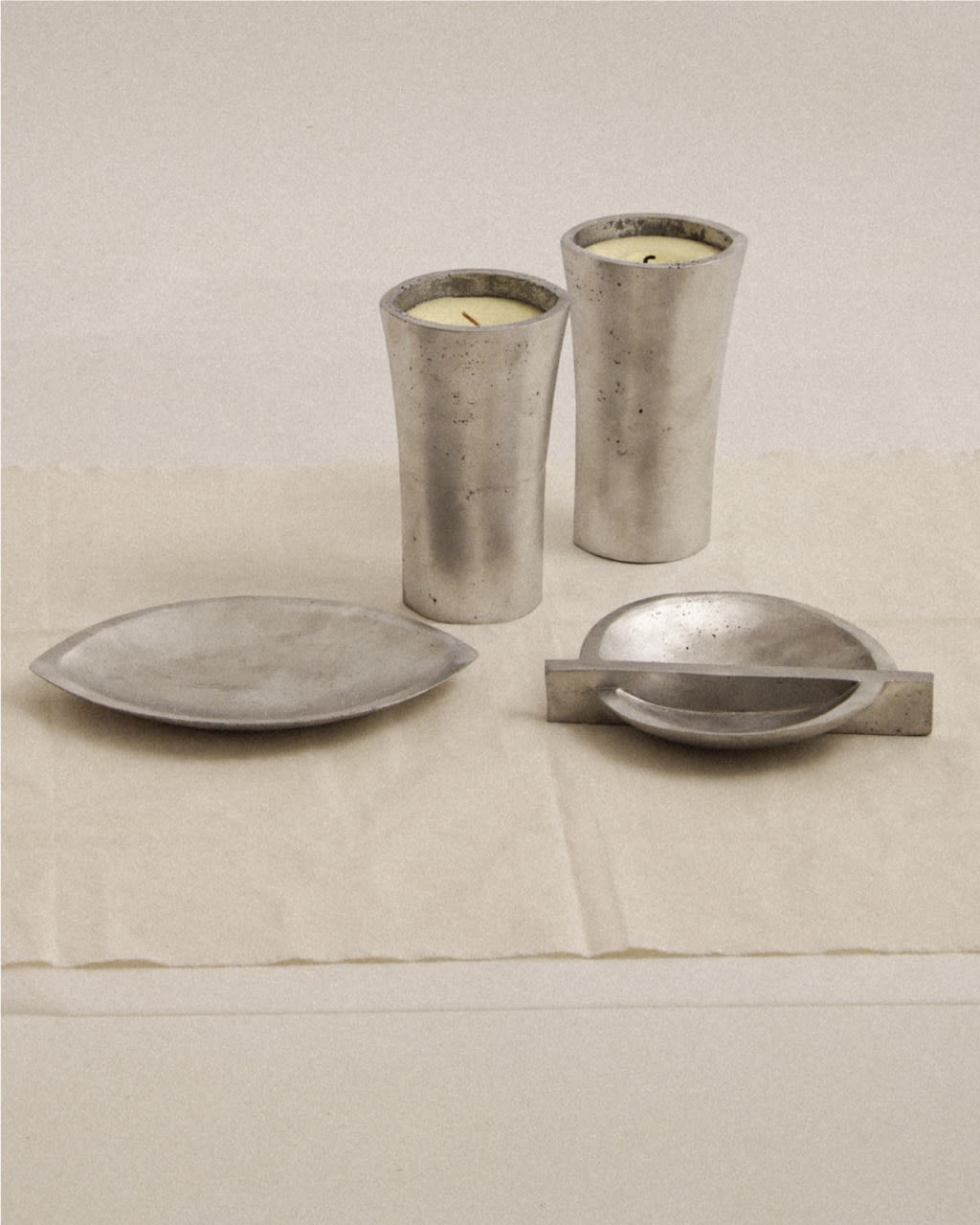 Aluminium Candle Sculpture — arranged on neutral fabric backdrop