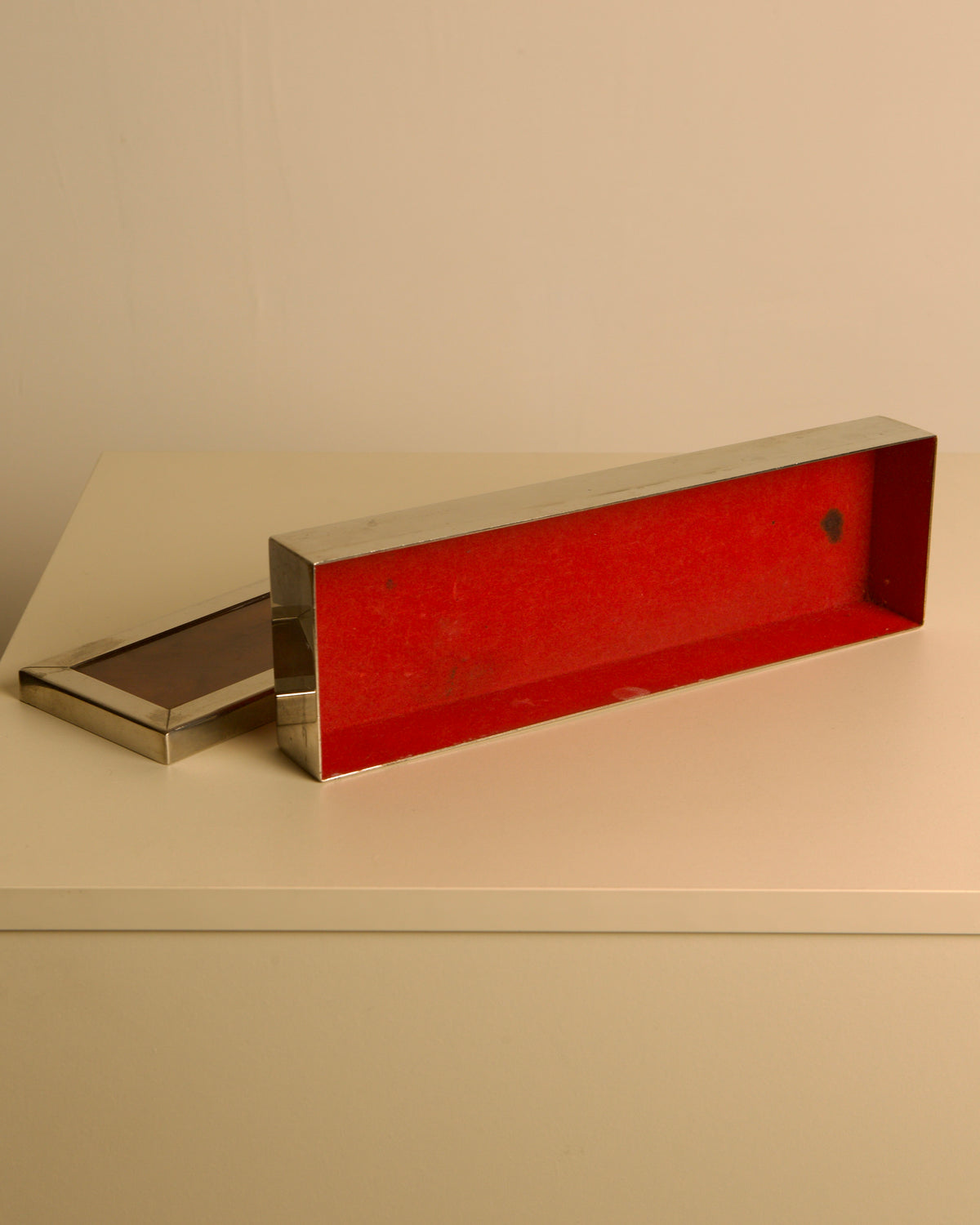 Rectangular Italian Metal Box, 70s — angled view with red interior on neutral surface