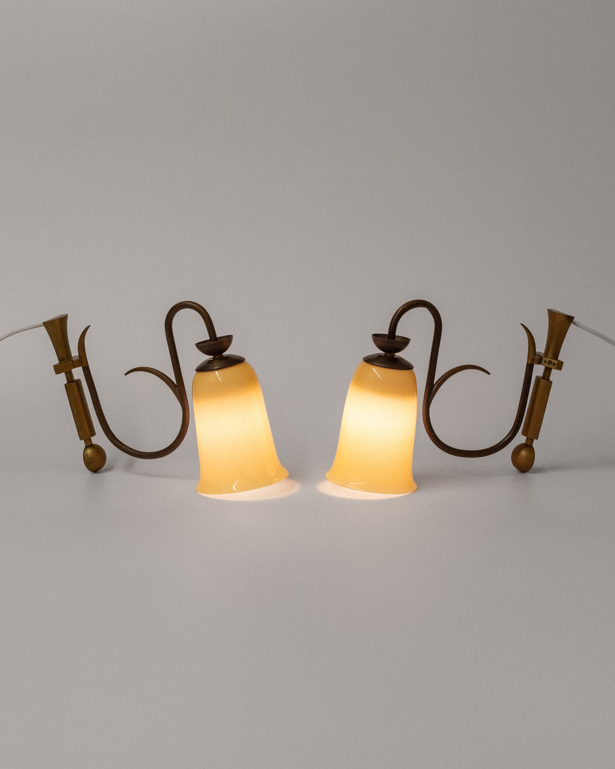 Art Deco brass wall sconces with amber glass shades, 1930s pair