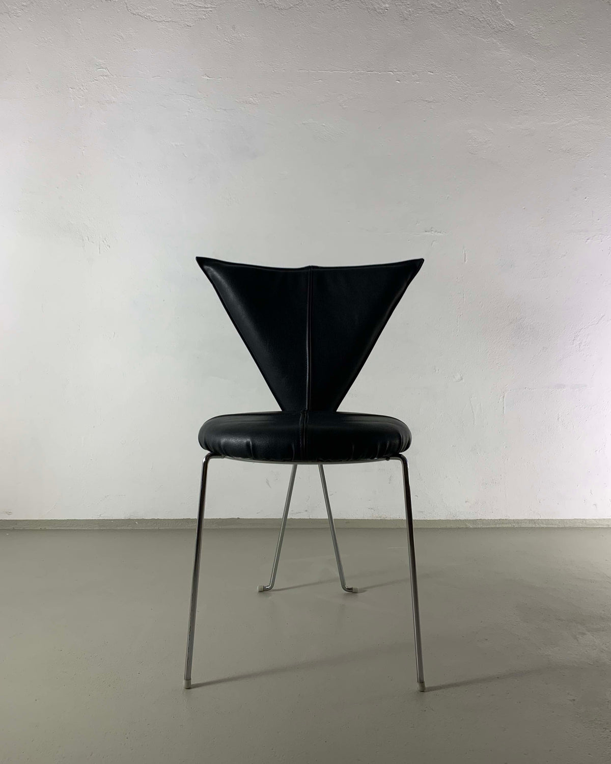 Black leatherette Lubke chair with triangular backrest on metal legs