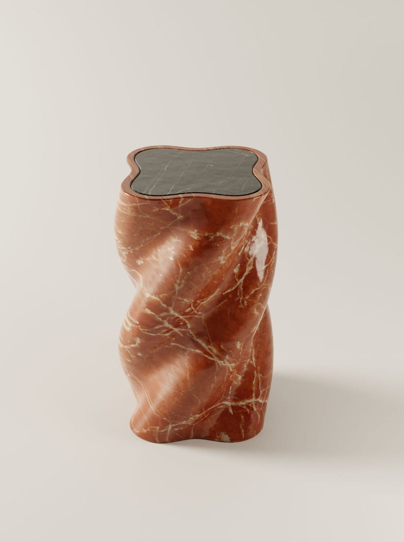 Sculptural red marble end table with organic twisted form