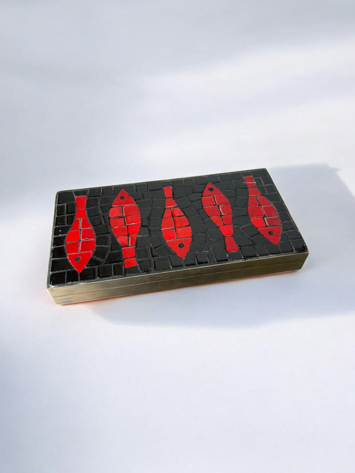 Italian 1960s Fish Mosaic Trinket Box in Ceramic and Brass — side angle showing red fish design on black surface
