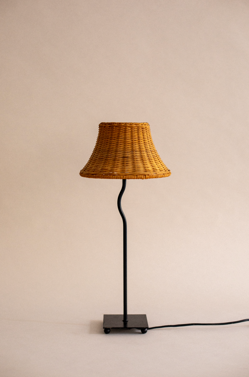 Woven rattan table lamp with black metal stand by SÒLER