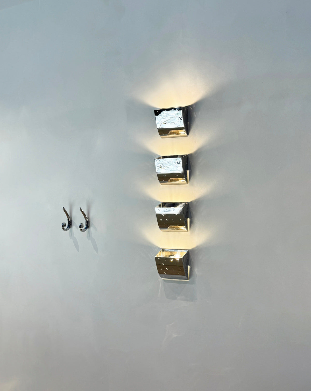 Jolene Wall Lamp - Polished Brass — mounted on wall with light effect