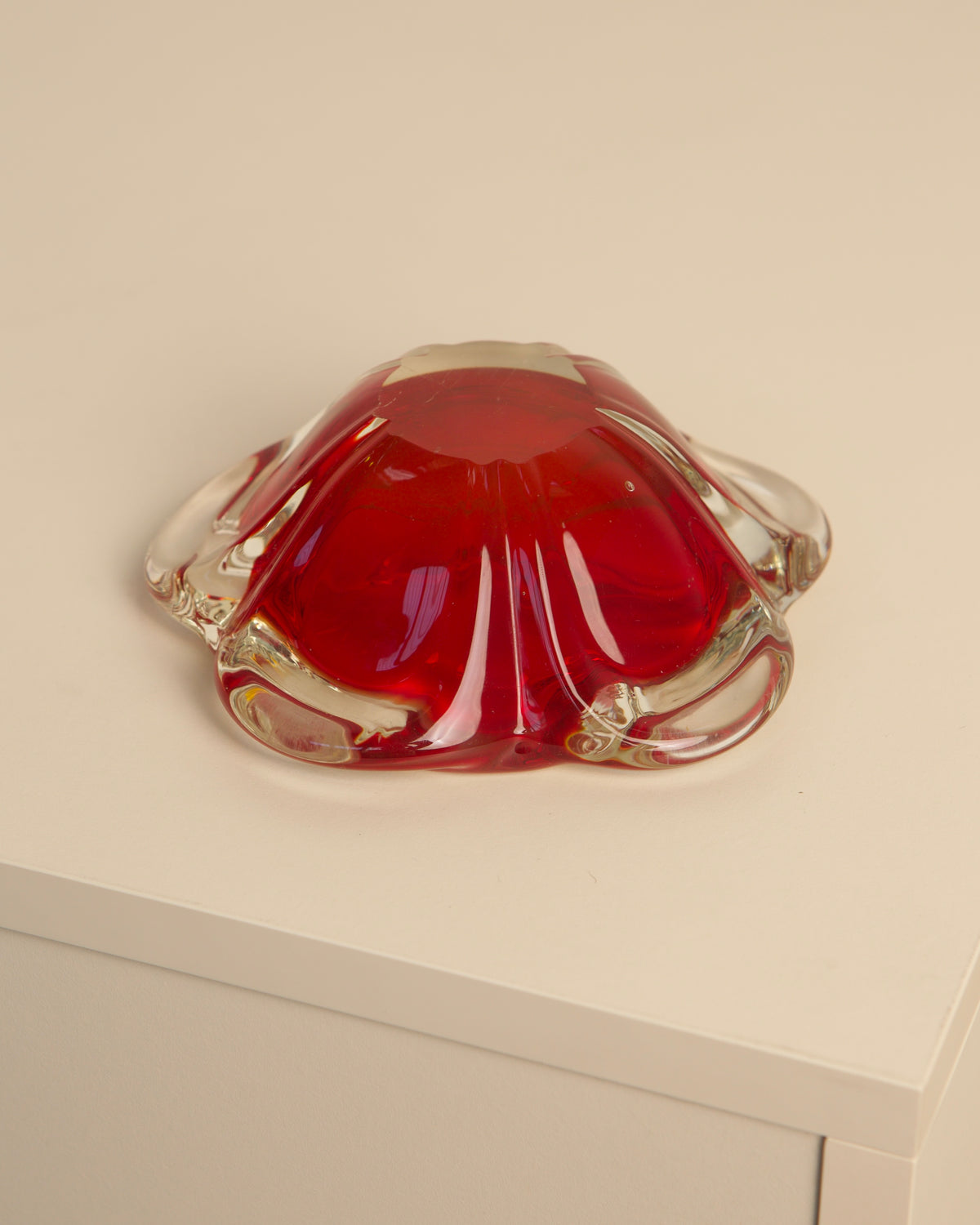 Red Murano glass flower-shaped ashtray showing curved petals detail