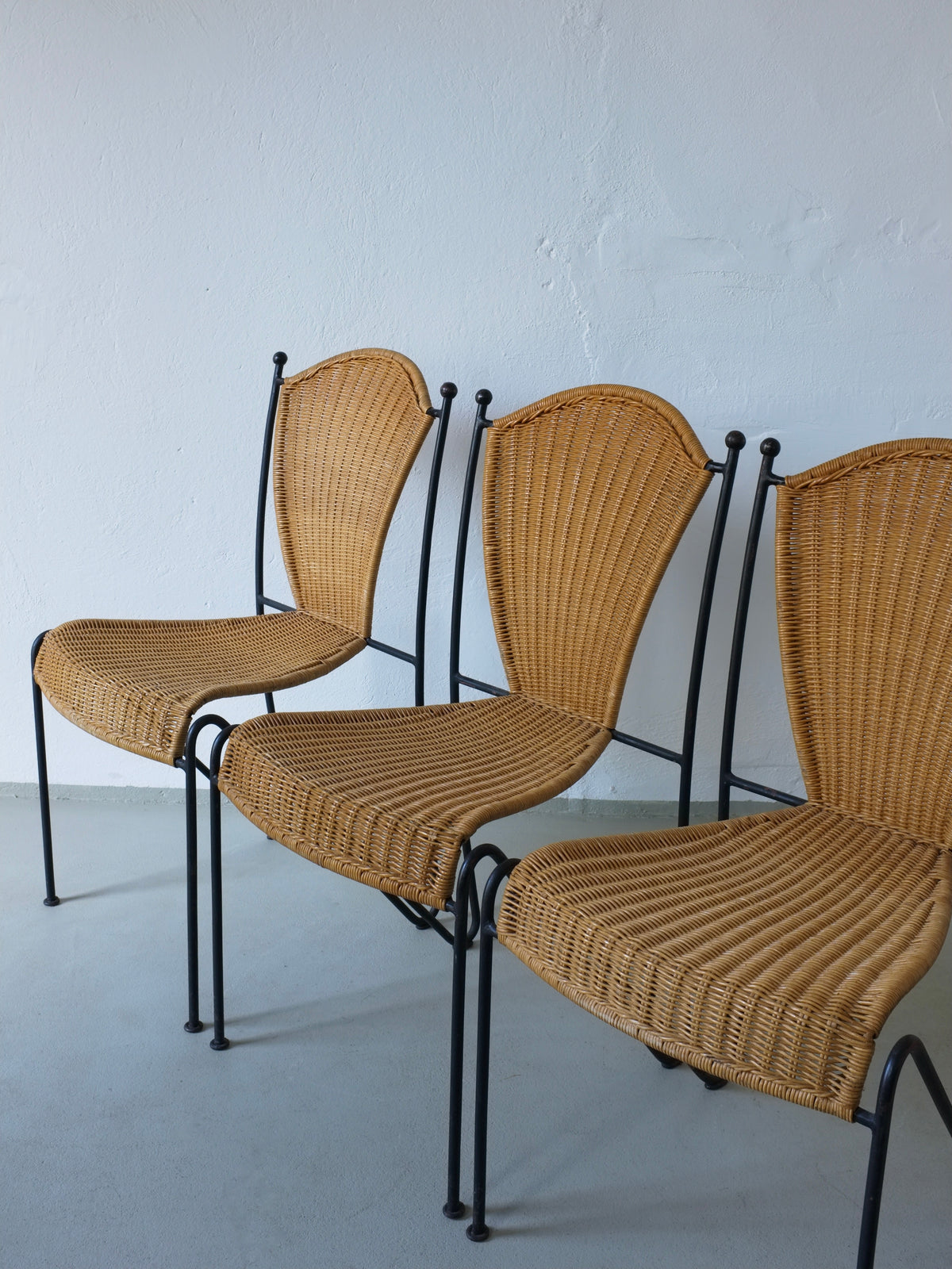 Three 1960s Frederick Weinberg wicker chairs with black iron frames