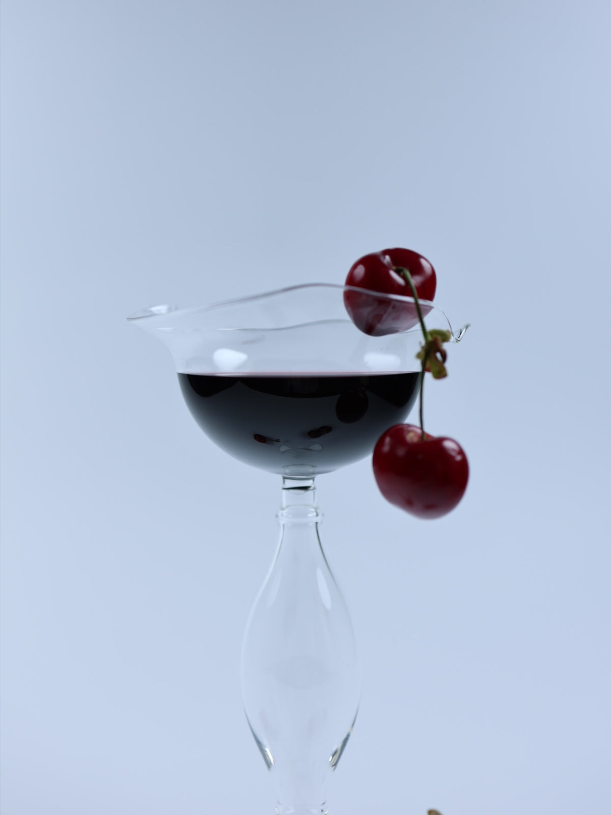 Crater wine glass with cherries showing distinctive layered design