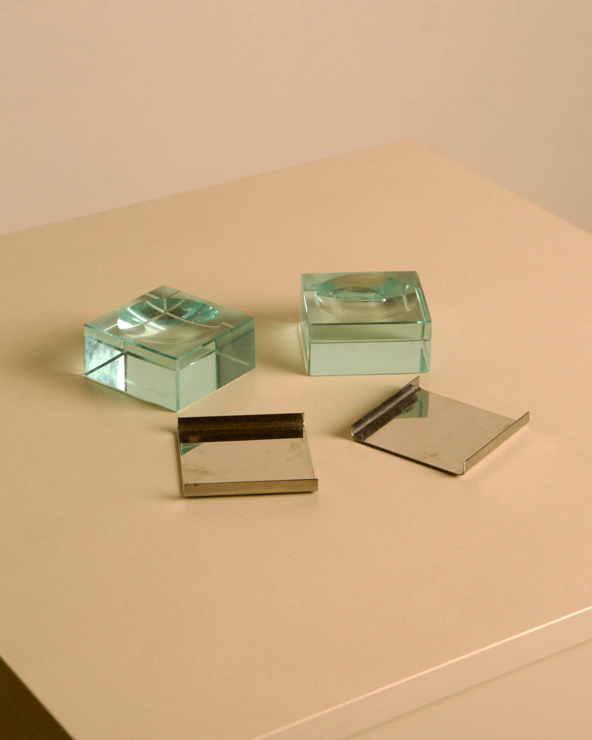 Pair of glass and metal ashtrays by Fontana Arte, 1960s — lifestyle setting