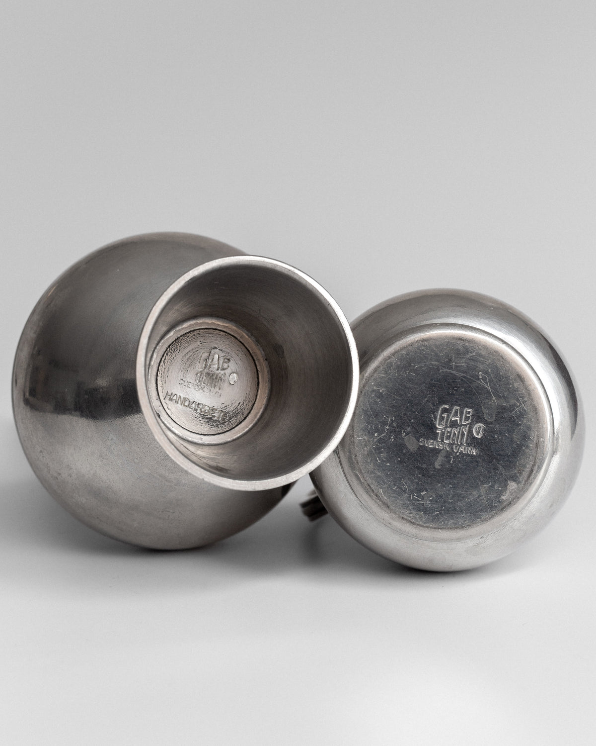 Pair of Pewter Vessels by GAB, Sweden, 1950s — back view showing smooth metallic finish