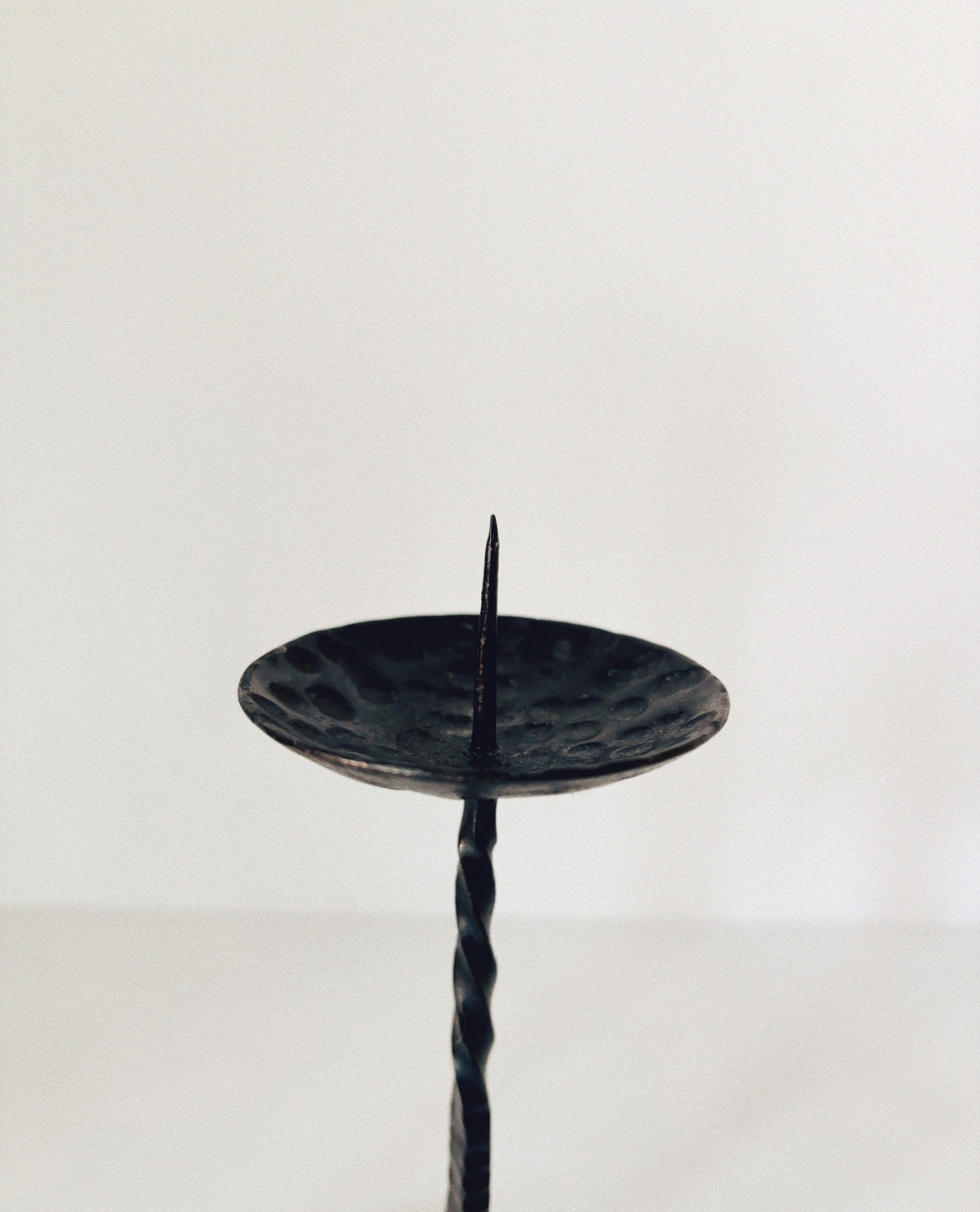 Forged Metal 2 Arm Candlestick, Poland — side view of textured black surface