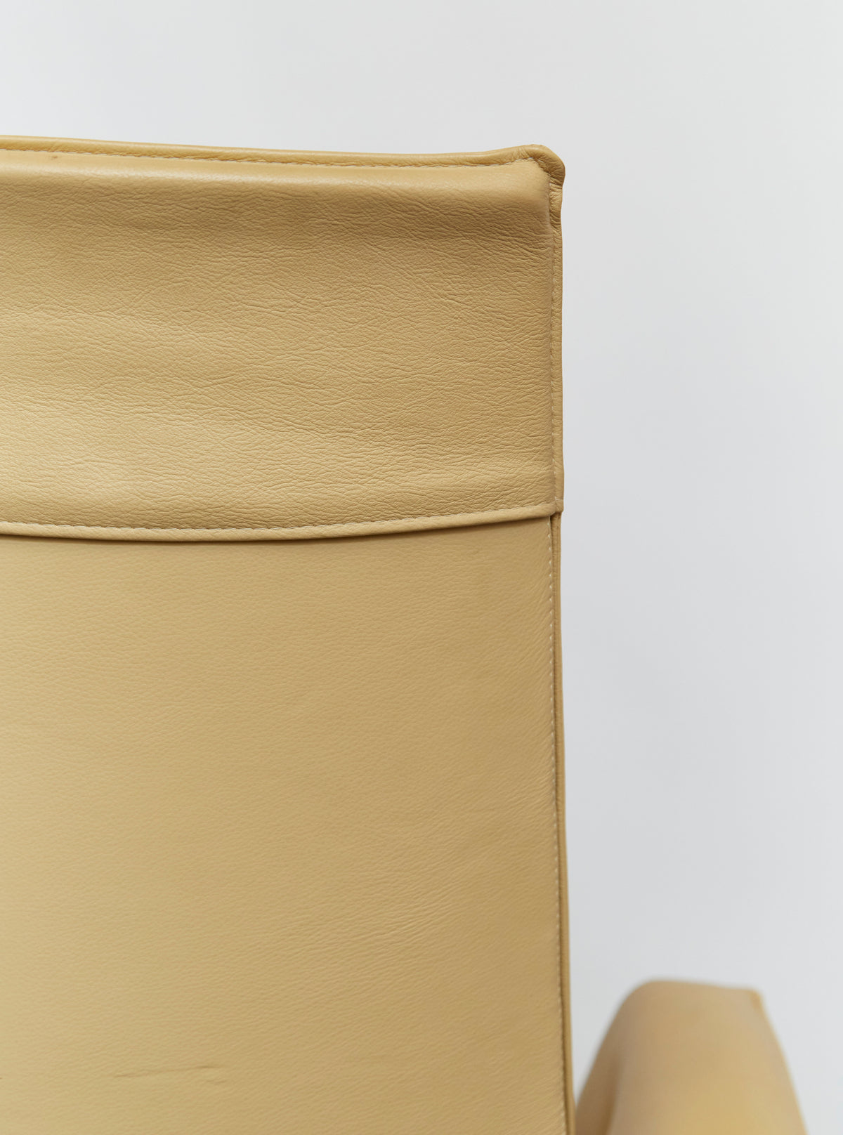 Close-up detail of beige leather upholstery on Tulip swivel chair