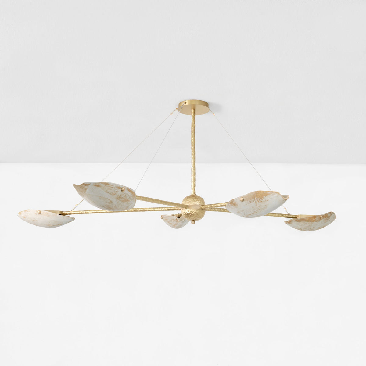 Serrallés Chandelier — close-up of gold metal arms with white shades