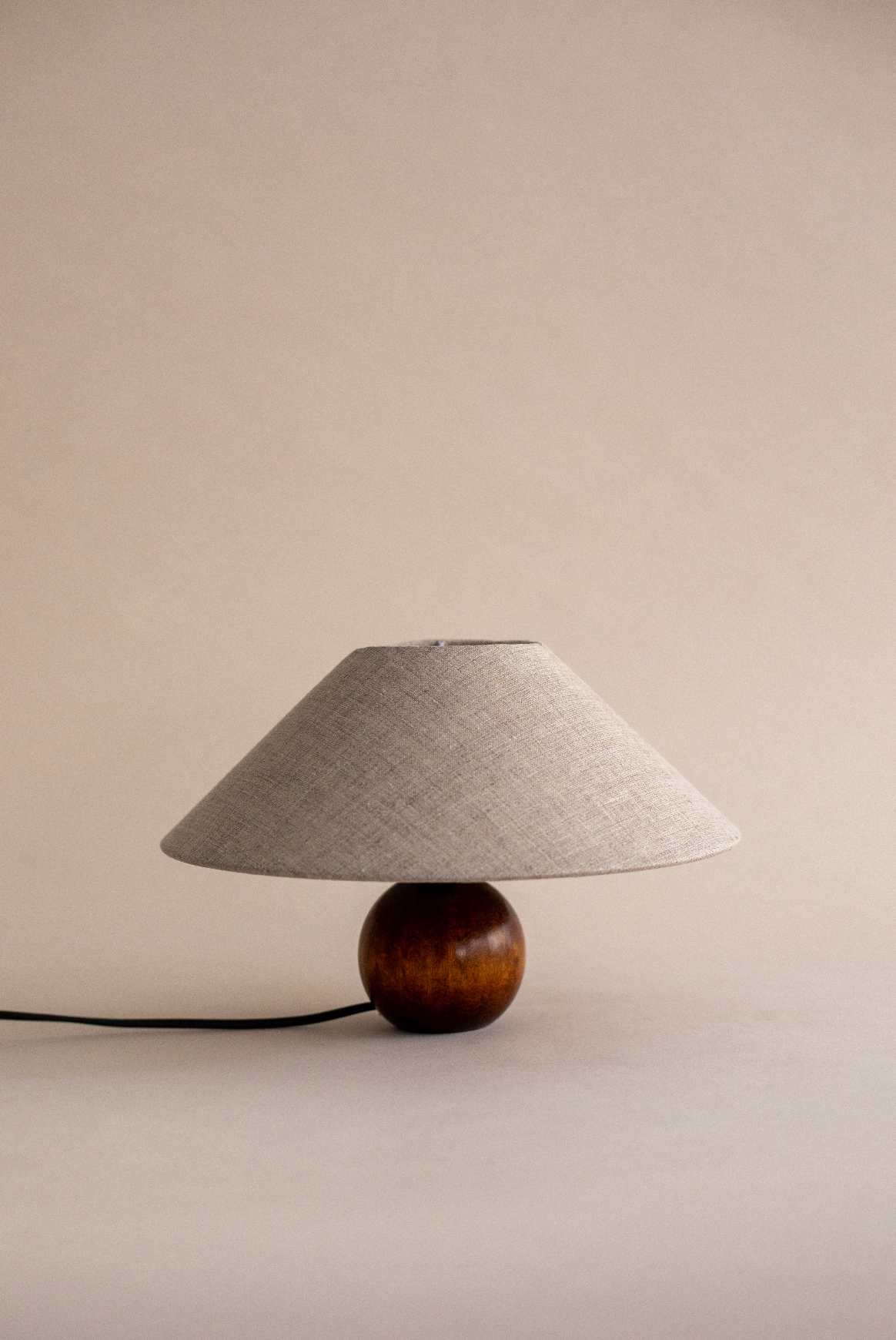 Pico table lamp with wooden base and beige linen shade by SÒLER