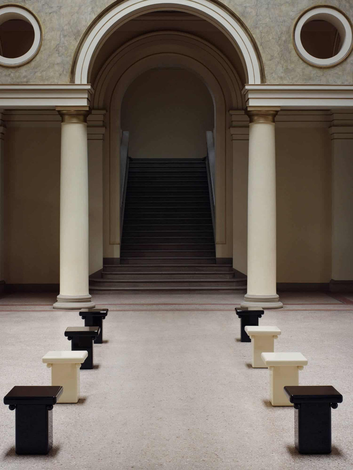Stool - Bench in Black Laquer — side angle in minimalist gallery setting