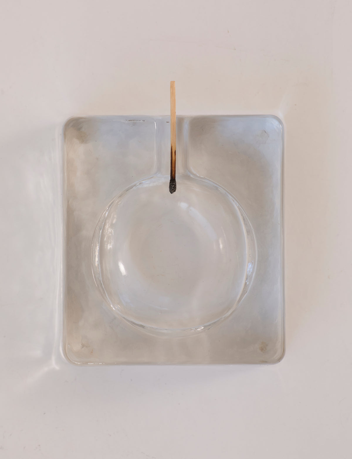 Scandinavian Clear Ashtray in Glass — top view on white surface