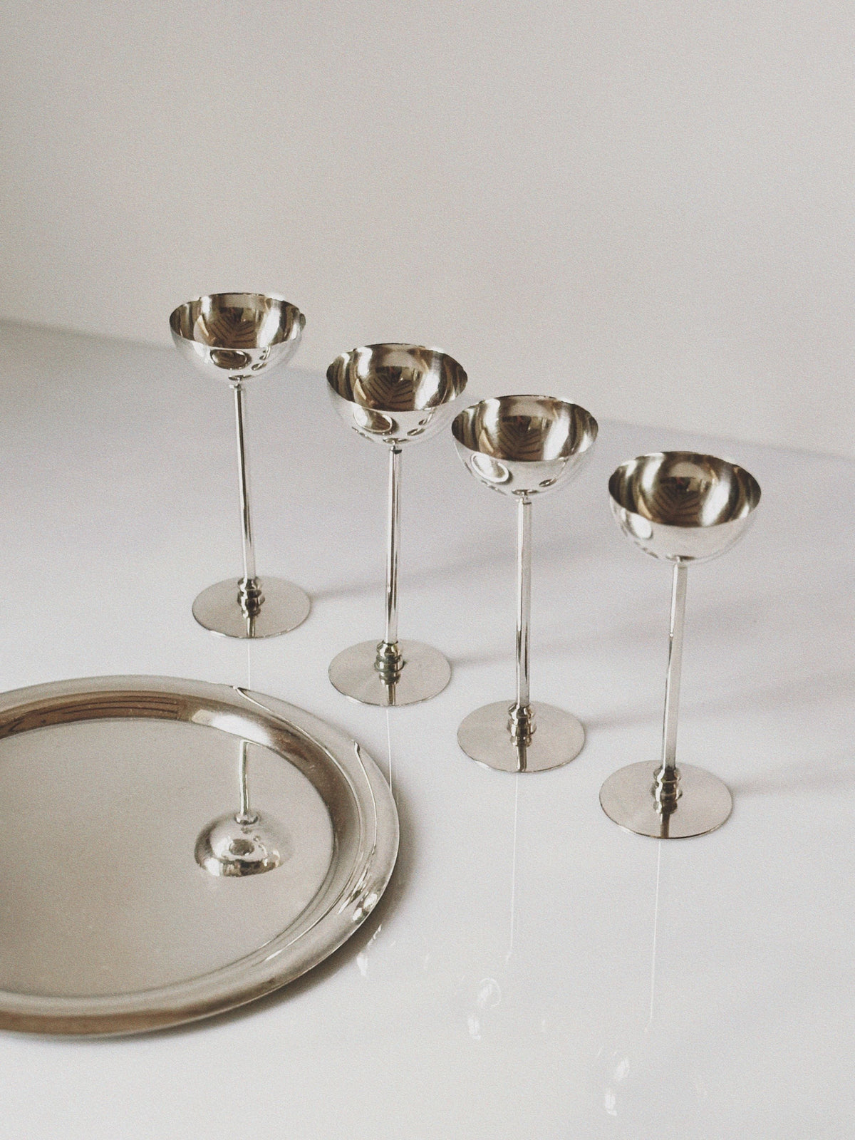 Set of four silver-plated champagne coupes with matching tray