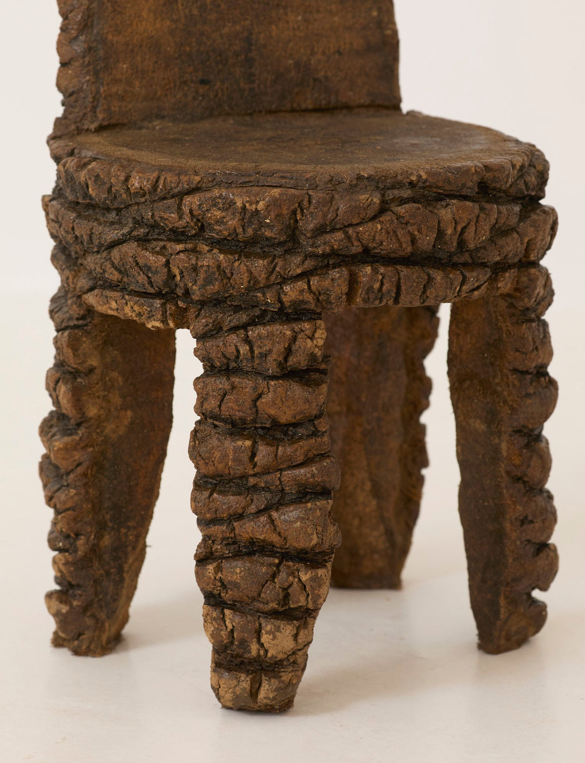 Small Artisanal Brutalist Chair in Solid Palm Tree C. 1970 — close-up of textured palm tree legs