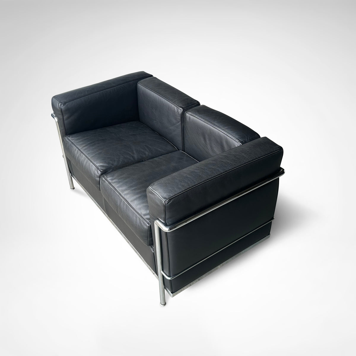 LC2 2-seater sofa by Le Corbusier et al. for Cassina 1990s — back view showing black leather upholstery and chrome frame