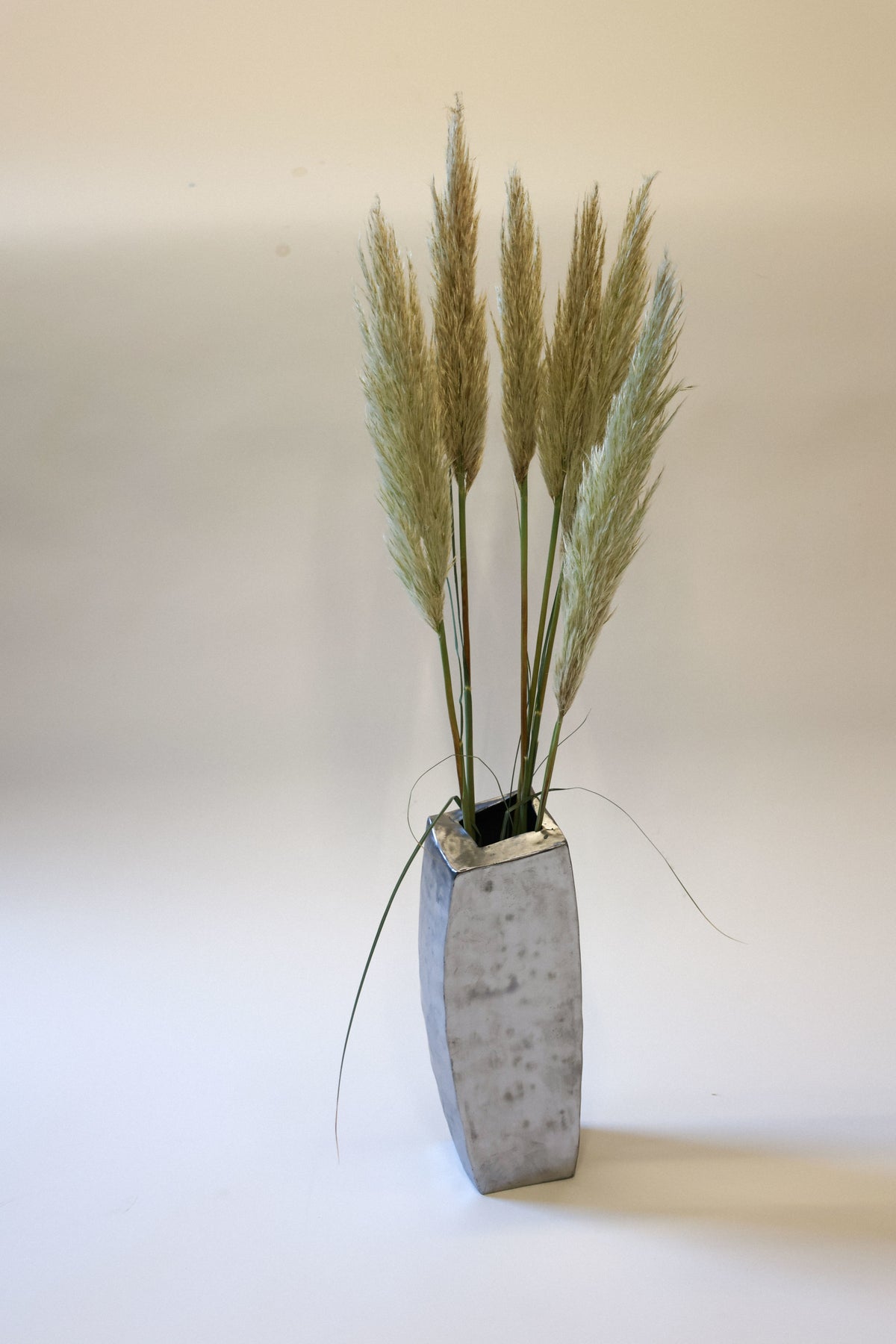 Hammered steel vase with dried pampas grass arrangement