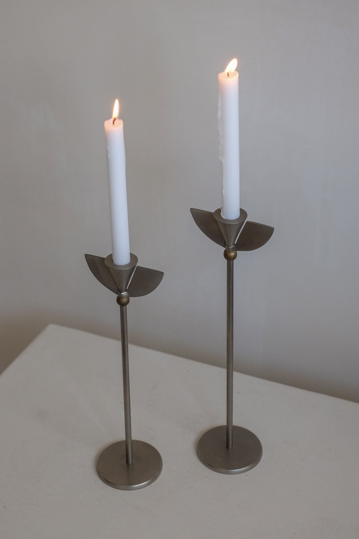 Set of 2 Memphis Candleholders — standing on light-colored table with white candles
