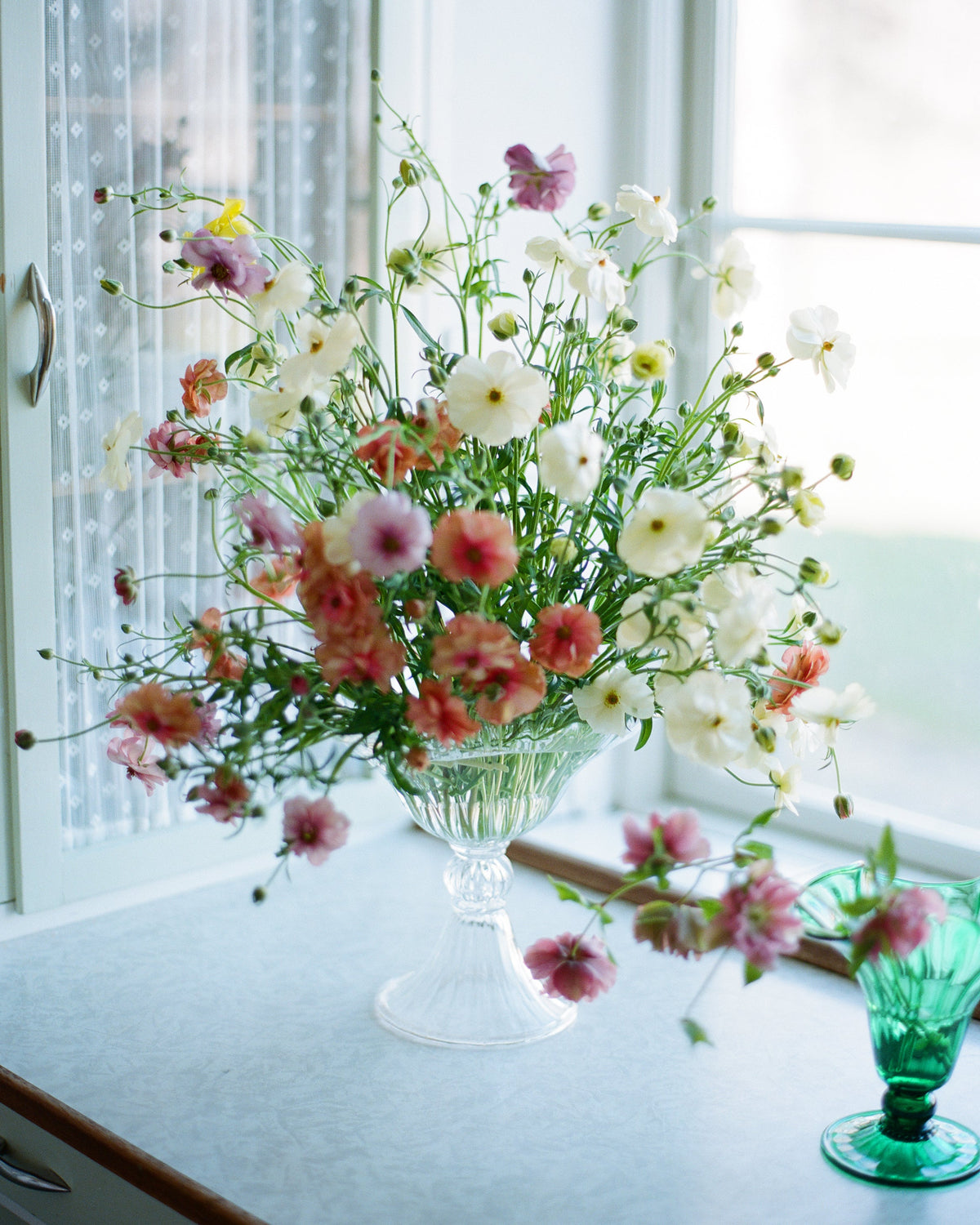 Blixen Vase Large — side view with floral arrangement in glass