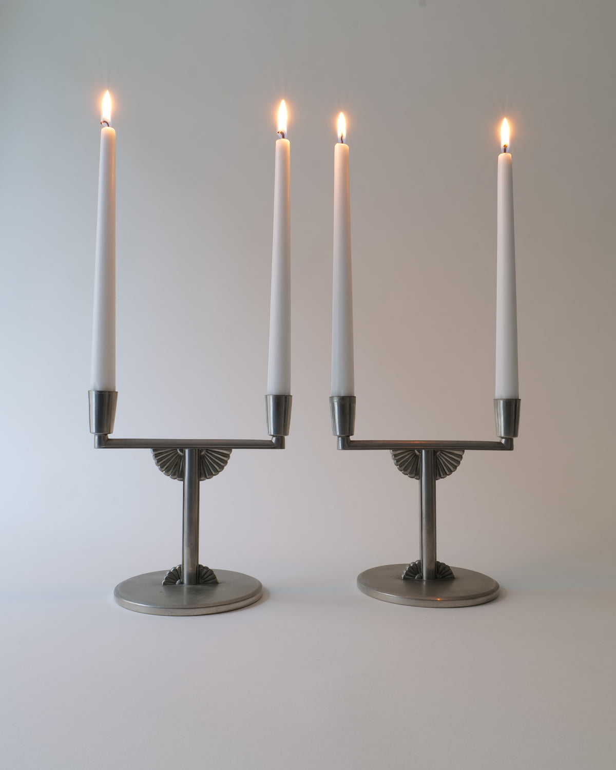 Vintage Candle Holders - Pewter Collection Sweden 1930s — close-up of candle holders with lit candles
