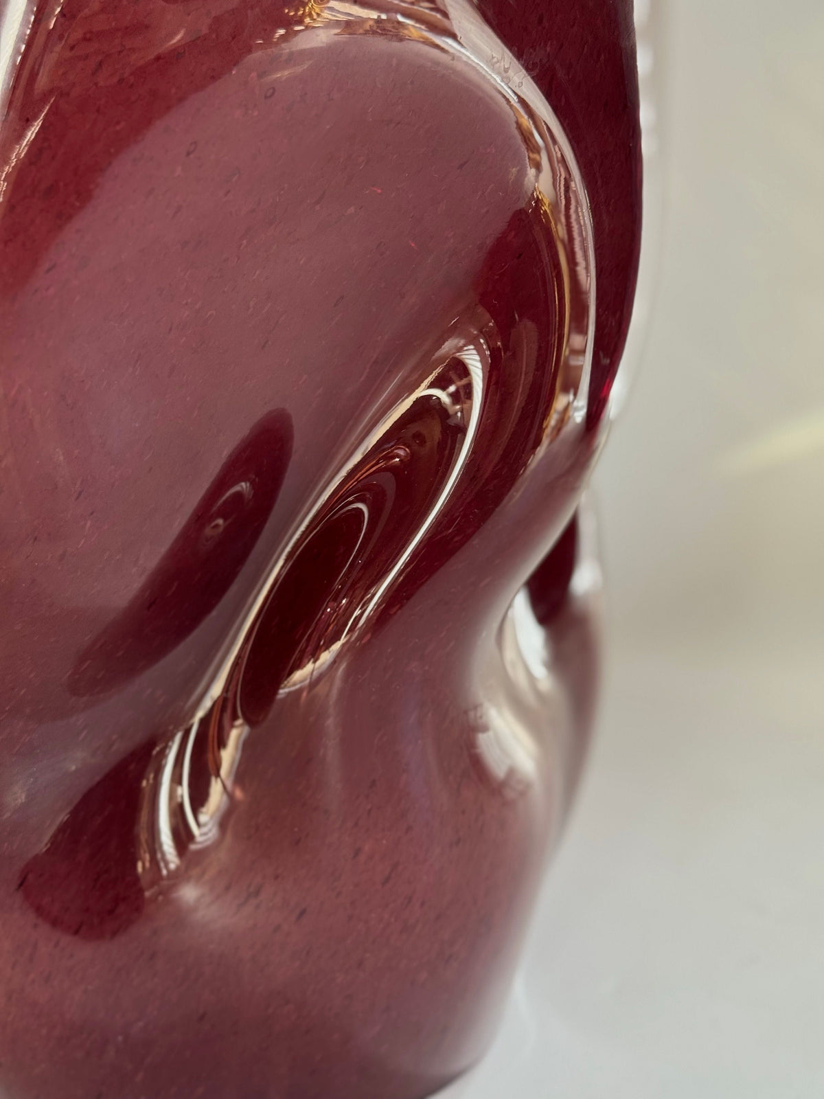 Wave Stool / Side Table VI — close-up of glossy burgundy surface
