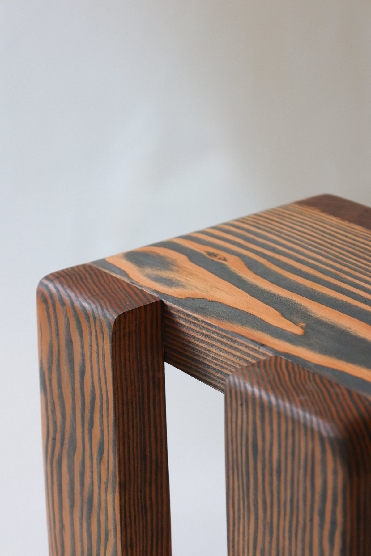 Close-up detail of Douglas fir wood grain on handcrafted stool