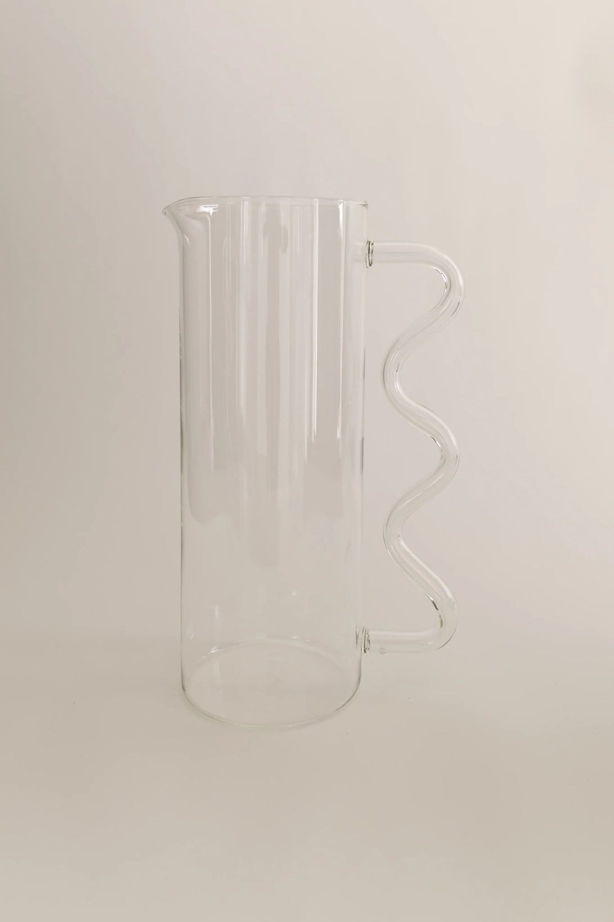 Wave Pitcher — back view of clear glass with wavy handle