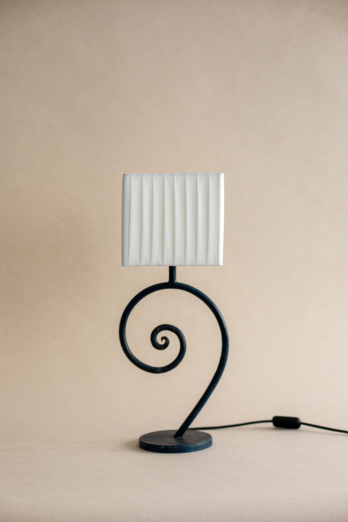 Nazaré table lamp with curved spiral base and pleated shade
