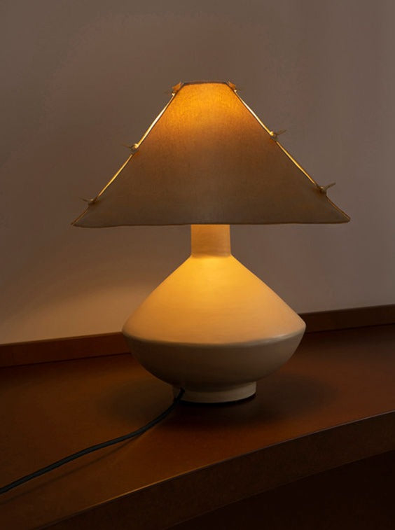 Bone ceramic table lamp with pagoda-style shade, warm glow