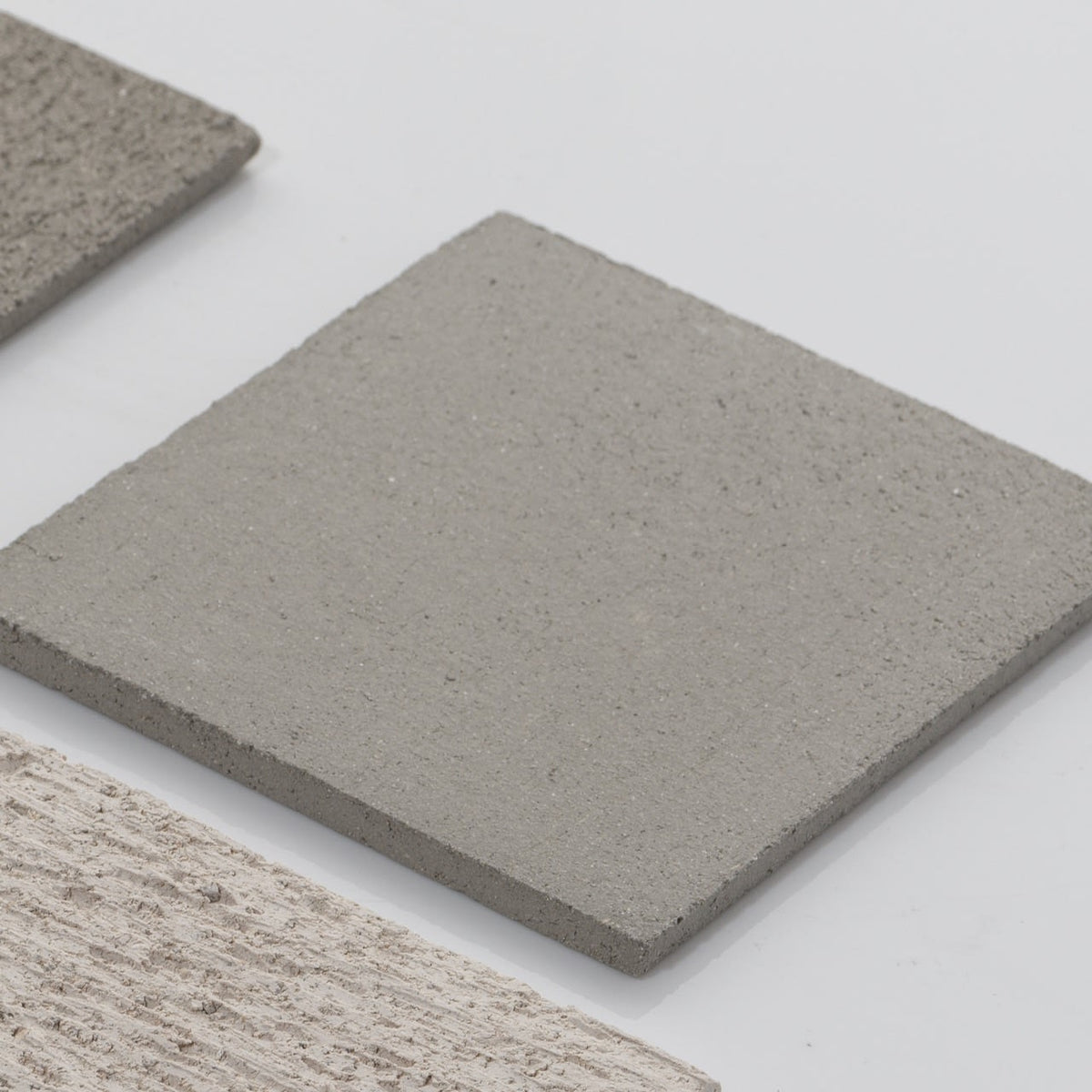 Too 60' Ceramic Table Lamp — view of lamp on textured concrete surface