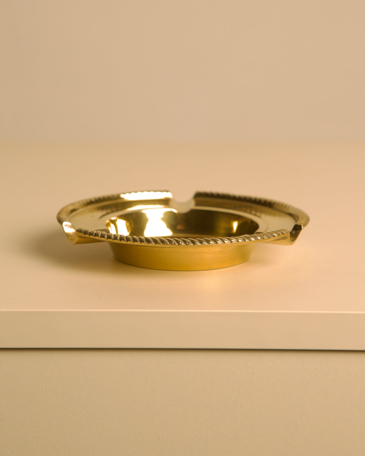 Italian Brass Ashtray DLG Jean Després 60's — side angle on white surface